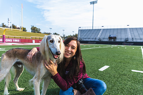 SIU Student Poses with White Saluki Dog