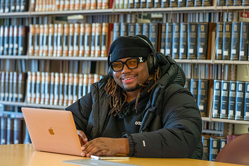 SIU student sits with laptop computer